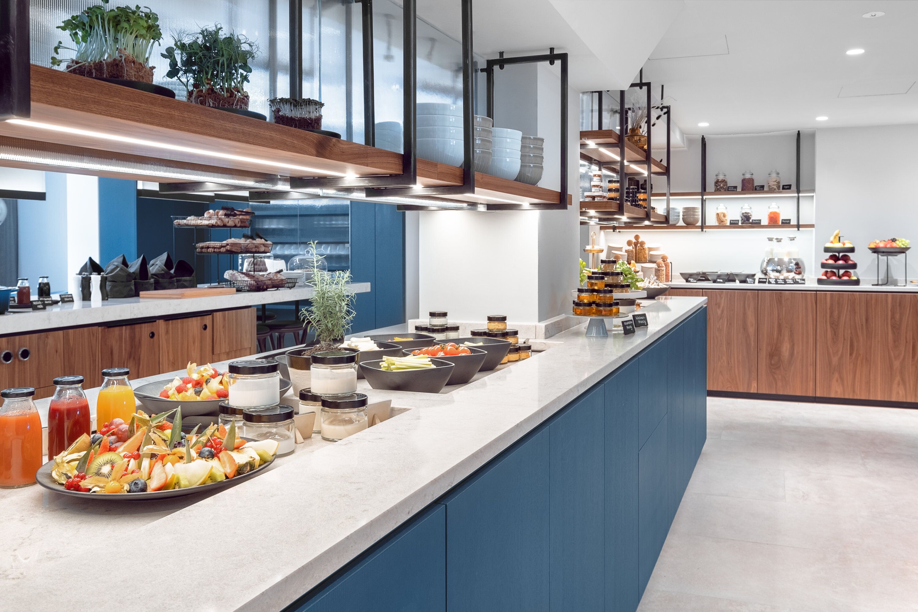 Une cuisine moderne dotée d’un long comptoir, de divers aliments et d’appareils de cuisine.