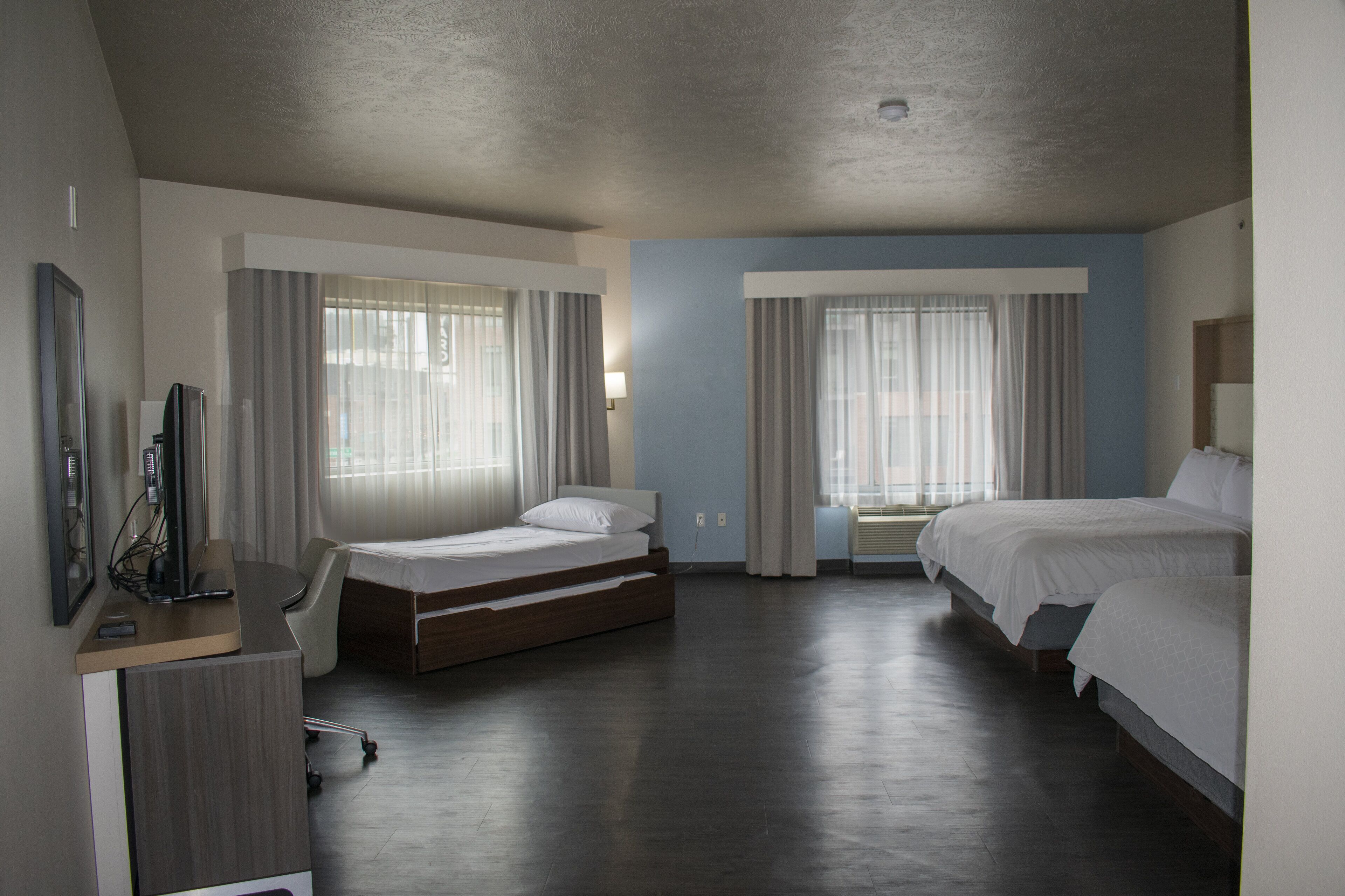 suite, multiple beds (tdm stadium view) | 1 bedroom, in-room safe, desk, iron/ironing board