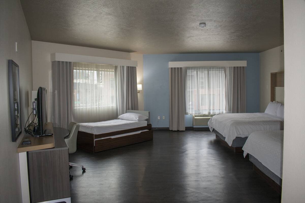 suite, multiple beds (tdm stadium view) | 1 bedroom, in-room safe, desk, iron/ironing board