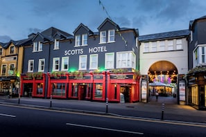 A hotel with a prominent sign, multiple windows, and a street view. - Scotts Hotel Killarney (Killarney)