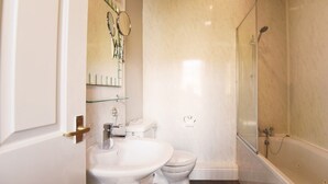 A bathroom with a toilet, sink, and shower. - Black Bull Inn (Wooler)