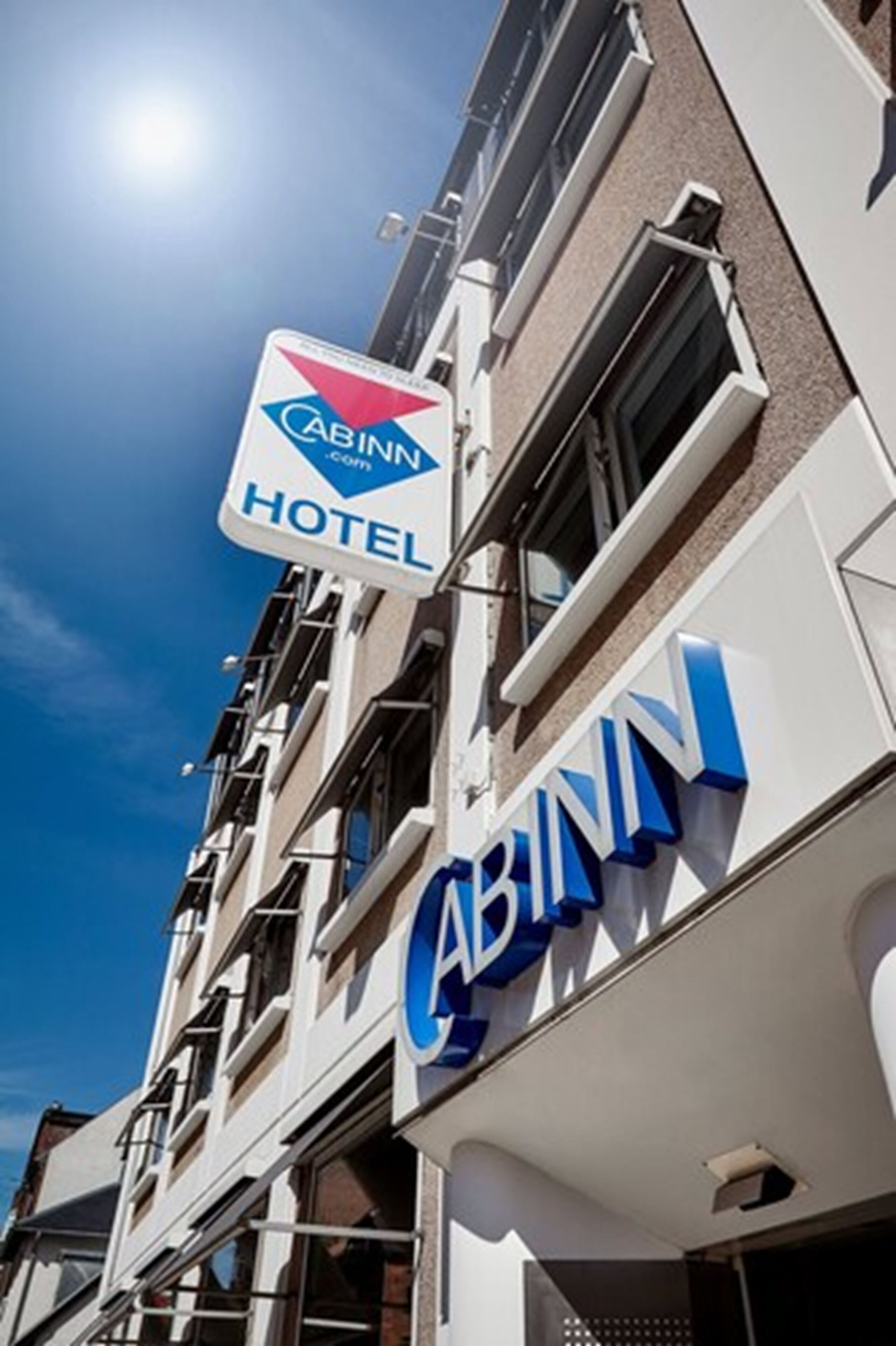 A multi-story building with a prominent 'Cabinn Hotel' sign.