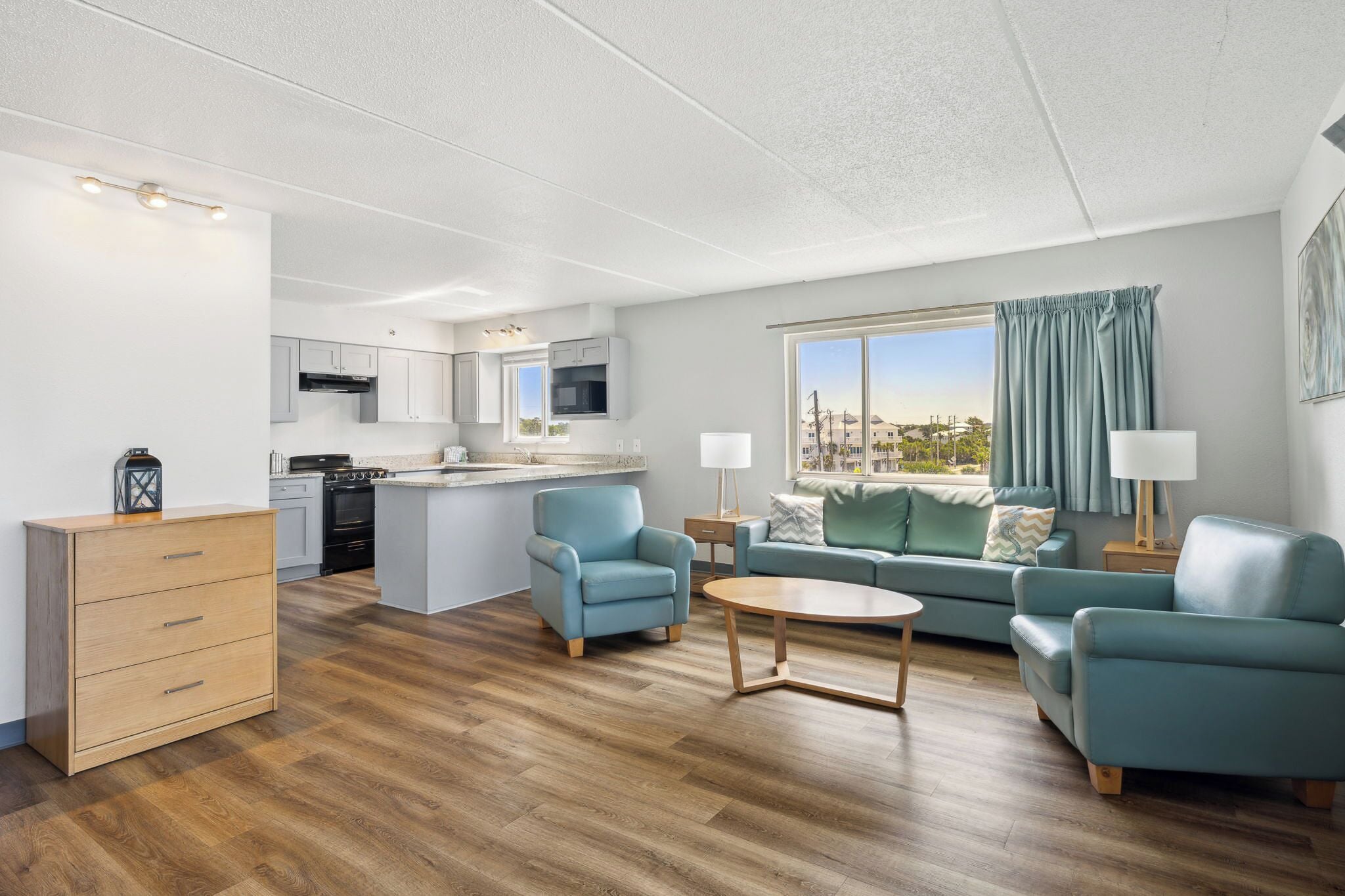 A modern apartment with a kitchen, dining area, and living room.