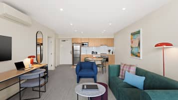 One Bedroom Deluxe | Living area | 50-inch Smart TV with cable channels, streaming services