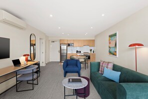One Bedroom Deluxe | Living area | 50-inch Smart TV with cable channels, streaming services - Quest Ivanhoe (Ivanhoe)