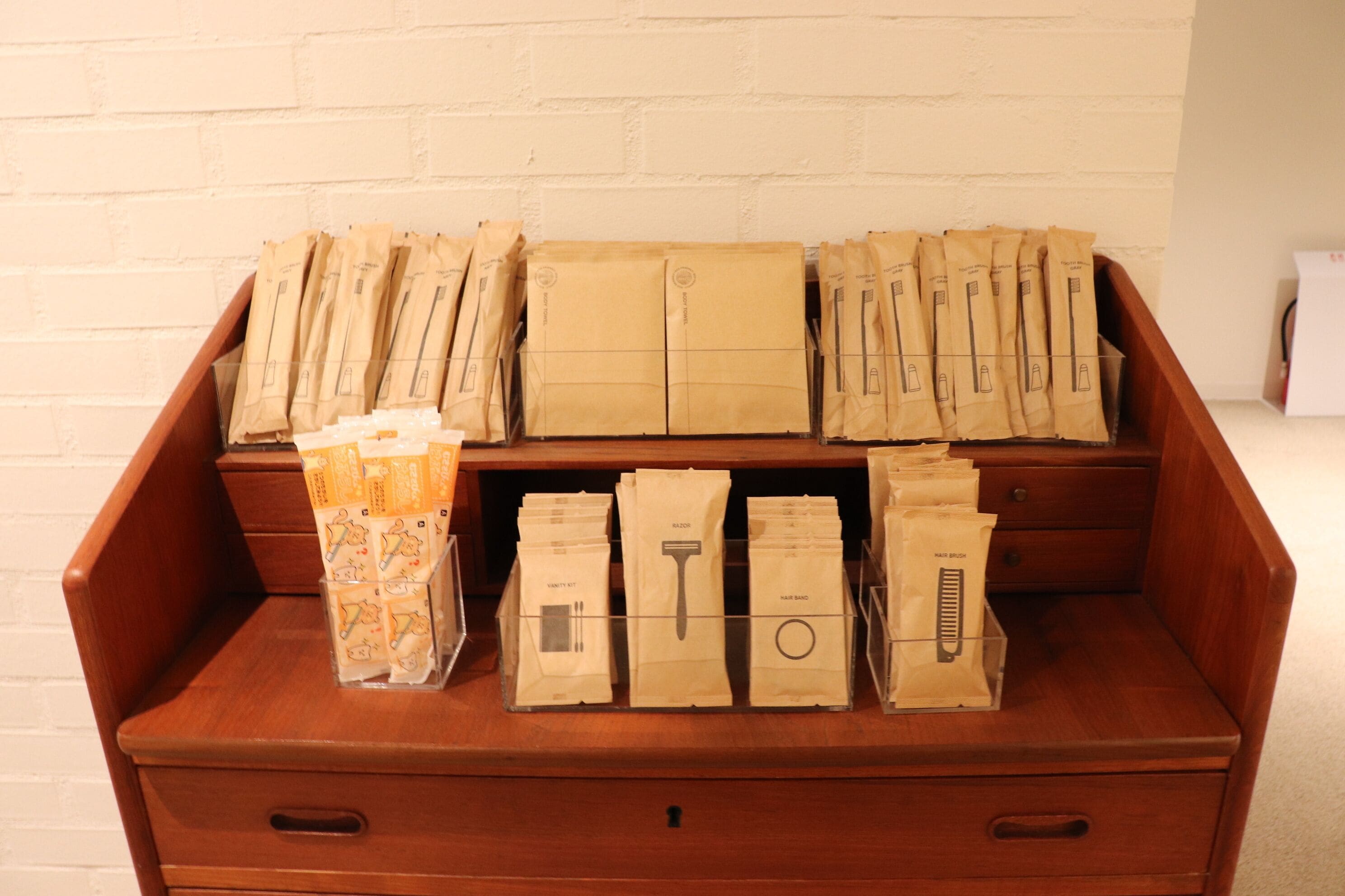 A wooden chest with multiple compartments containing various packages.