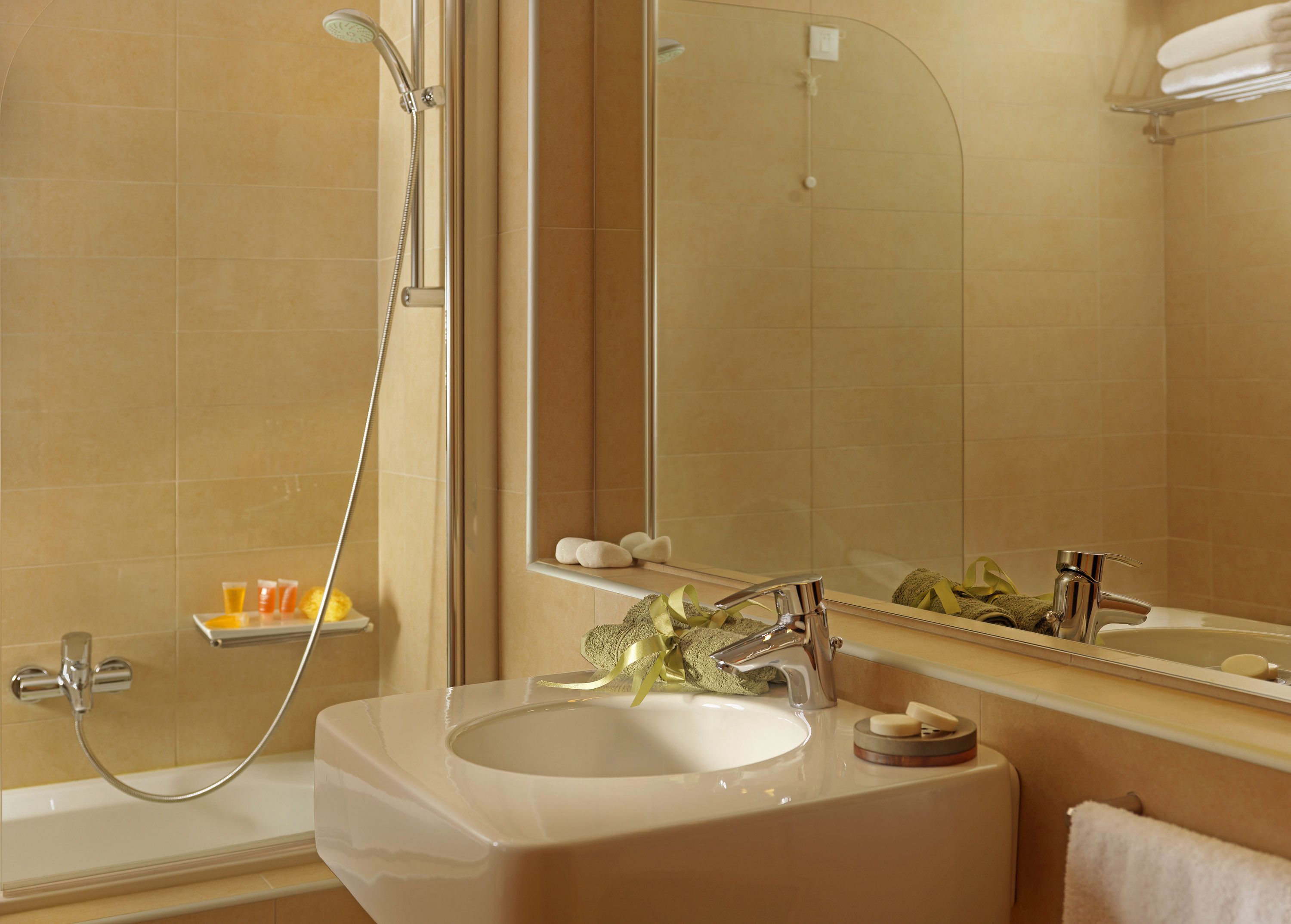 designer toiletries, hair dryer, slippers, towels