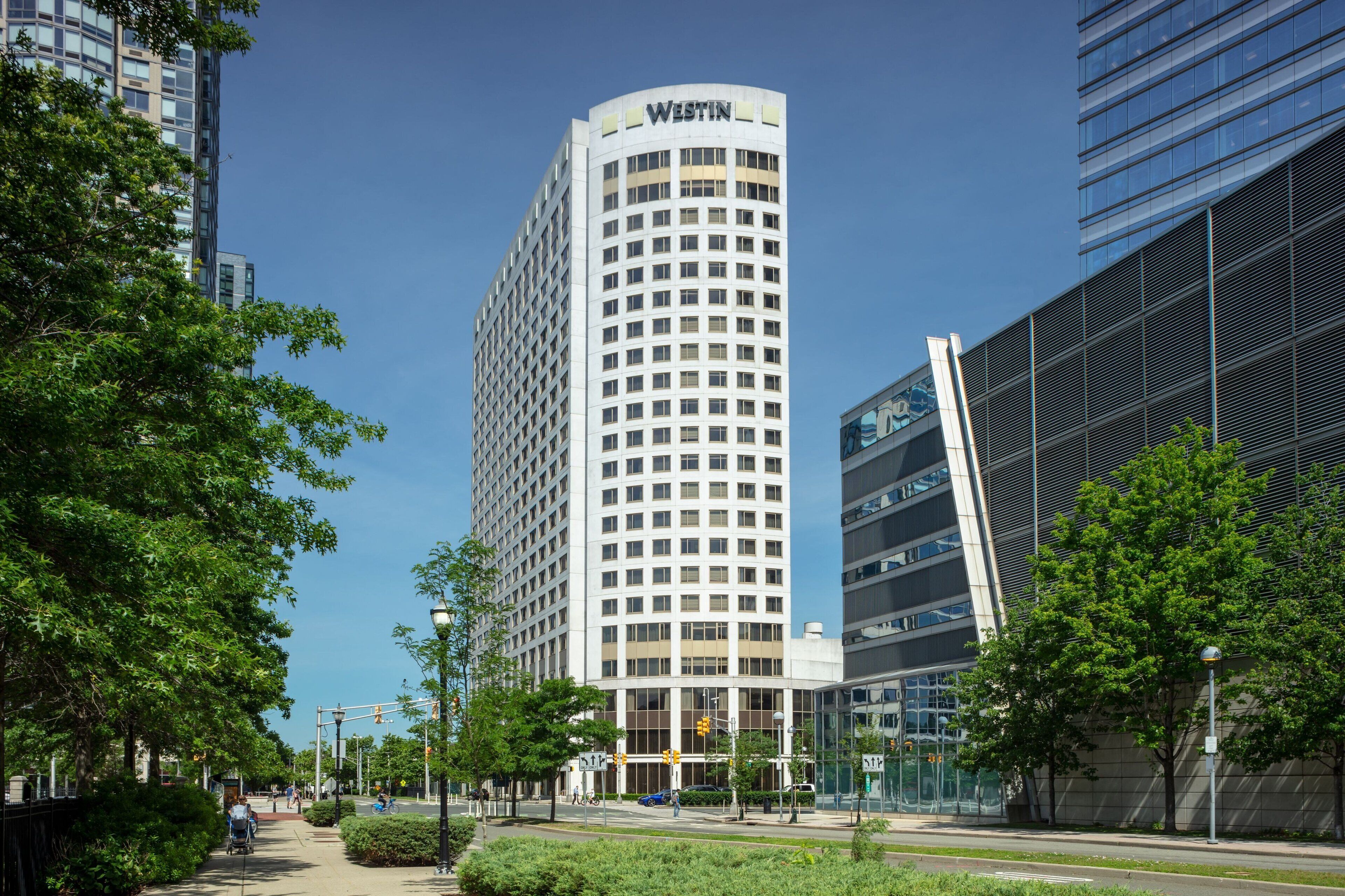 Een hoog hotel met een gevel in rasterpatroon en de naam 'WESTIN' bovenaan.