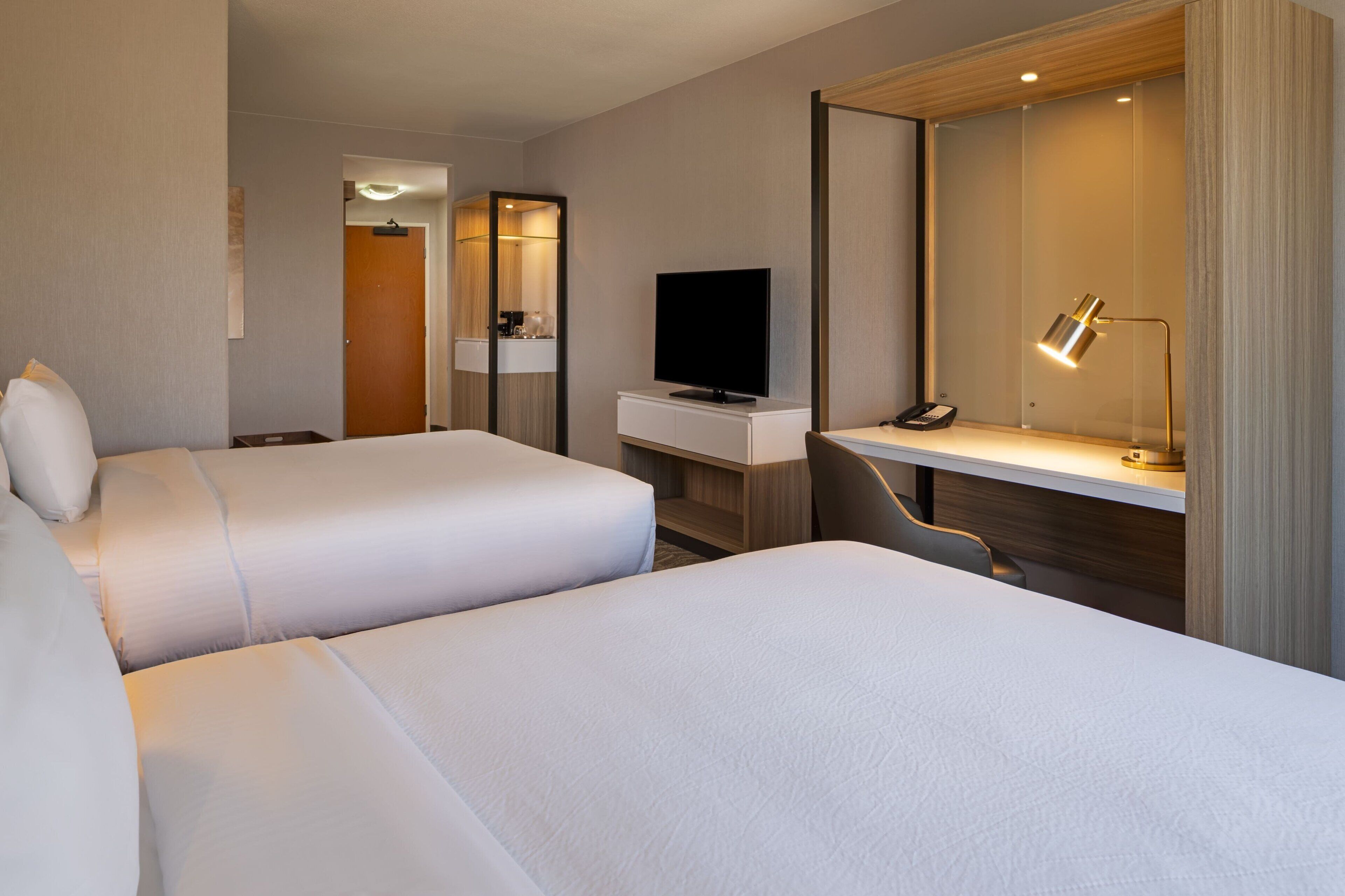 premium bedding, pillow-top beds, desk, laptop workspace