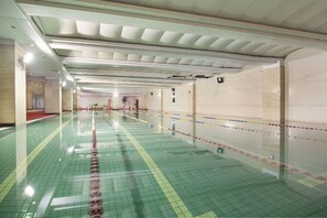 Relax by the long, narrow pool surrounded by a tiled floor.