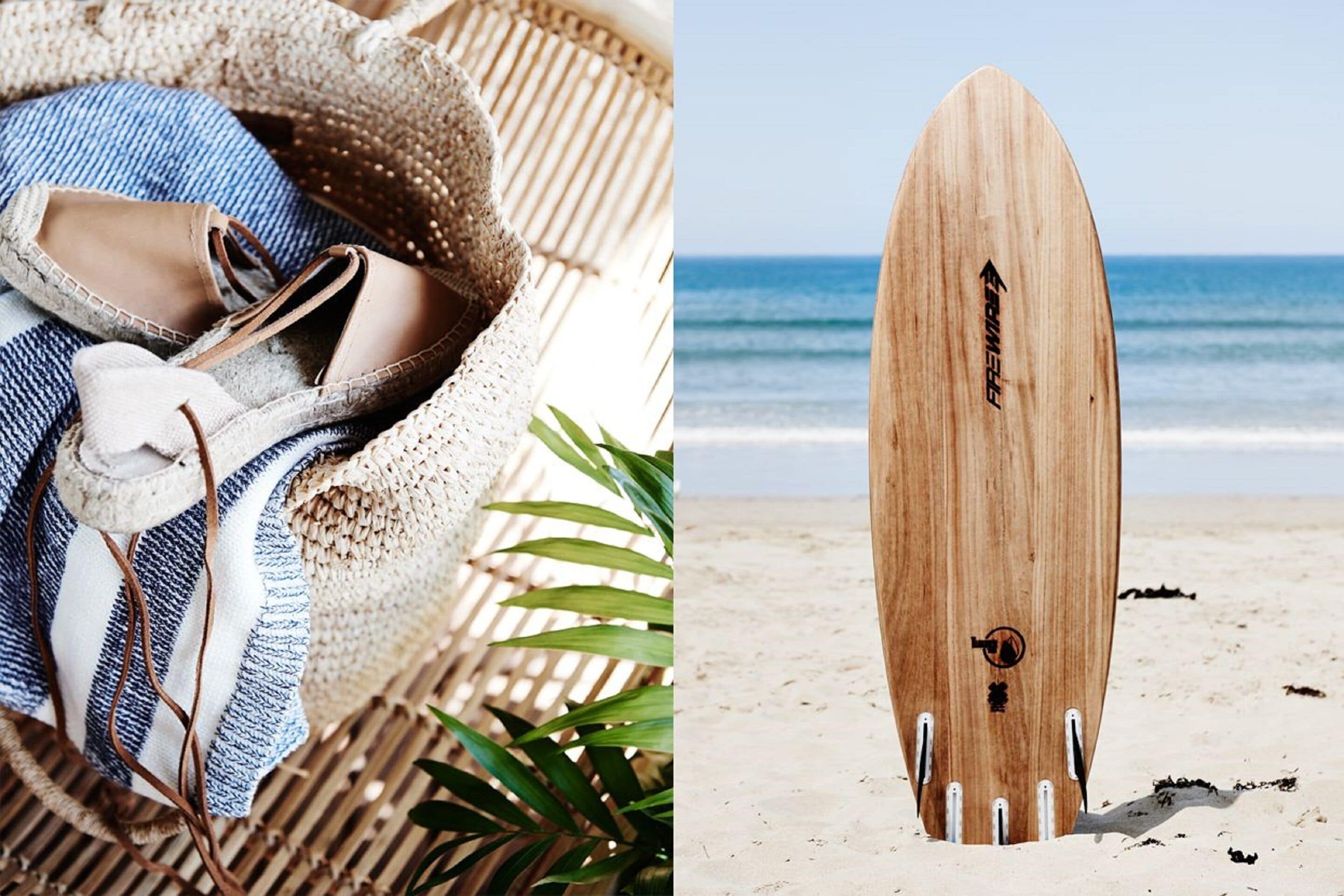 A wicker basket with shoes and a striped cloth, and a wooden surfboard on a beach.