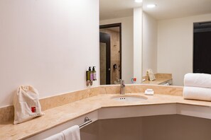 A bathroom with a sink, mirror, towel rack, and toiletries. - Fiesta Inn Express Tepic (Tepic)