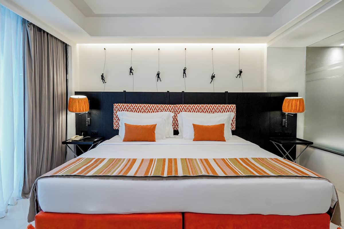 Deluxe Room, Pool View | 1 bedroom, in-room safe, individually decorated, desk