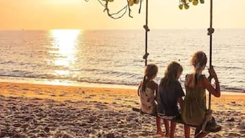 On the beach, white sand, beach umbrellas, beach towels