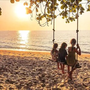 On the beach, white sand, beach umbrellas, beach towels