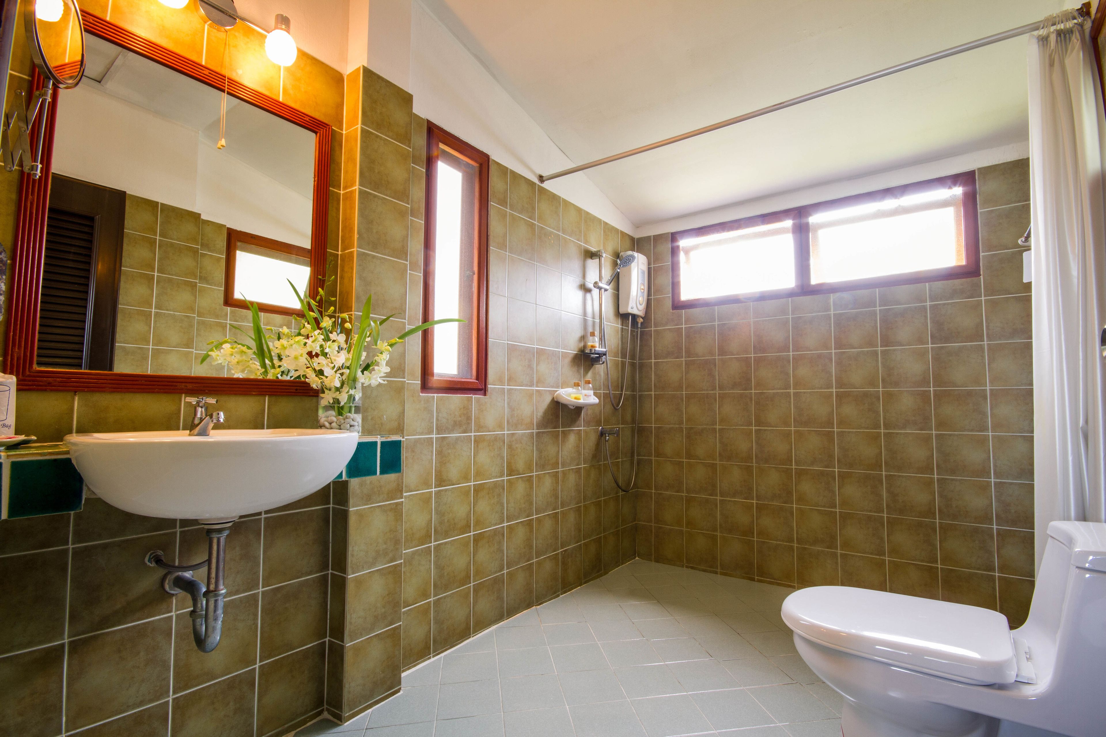 A bathroom with a sink, mirror, and toilet.
