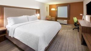 A hotel room with a large bed, a desk with a chair, a television, and a window. - Holiday Inn Express Hotel & Suites Ozona by IHG (Ozona)