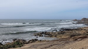 A rocky coastline with waves crashing onto the shore.