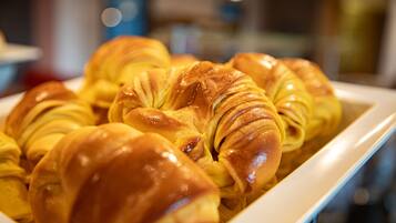 A tray of golden-brown croissants.