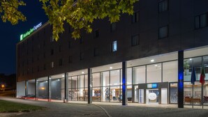 A Holiday Inn Express hotel with a modern glass facade, large windows, and a visible entrance.