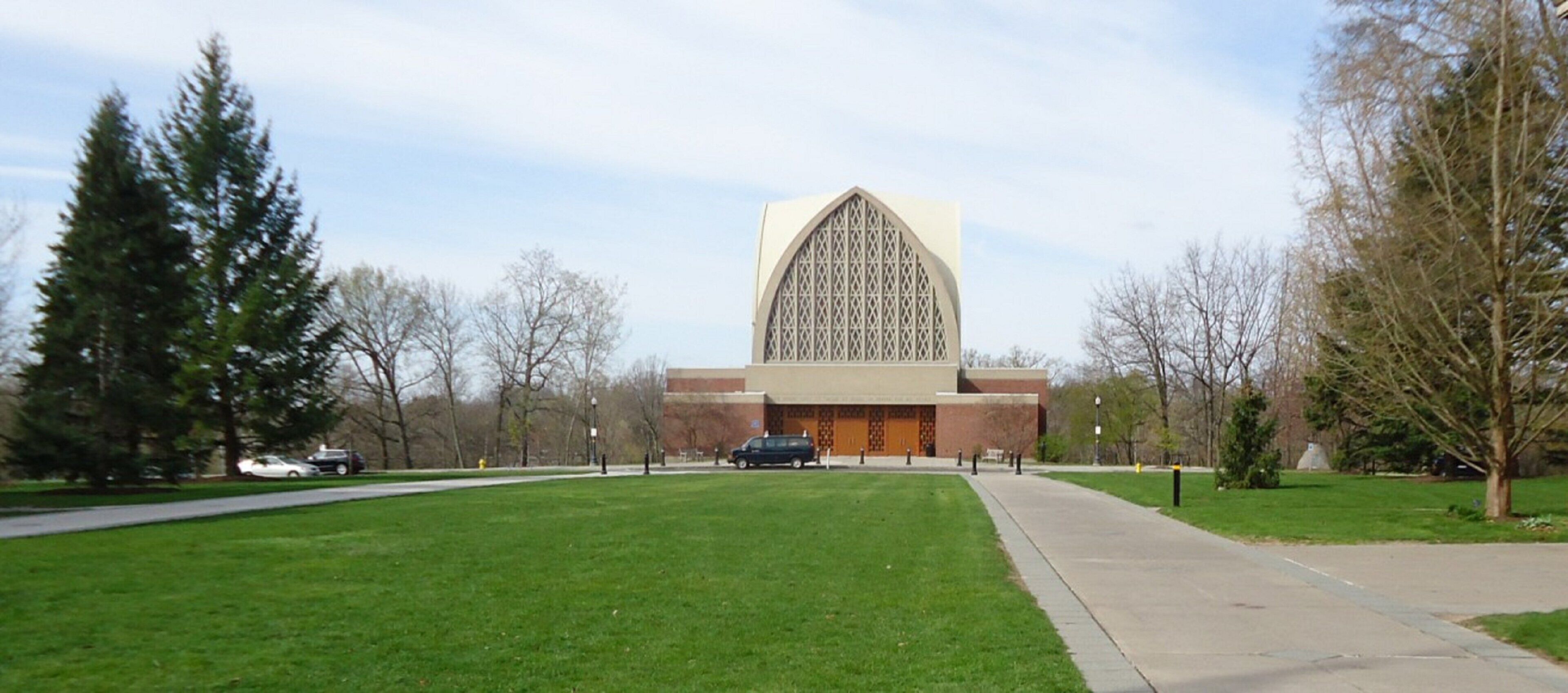 A large building with a prominent arched entrance and a symmetrical facade.