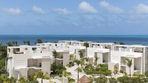 A resort with white buildings, palm trees, and a view of the ocean. - Beloved Playa Mujeres - Couples Only All Inclusive (Punta Sam)