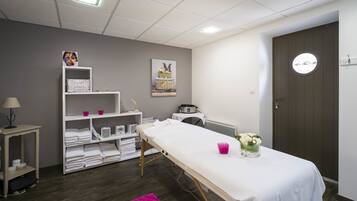 Relax in a serene space with a neatly made bed, a small table, and a shelving unit.