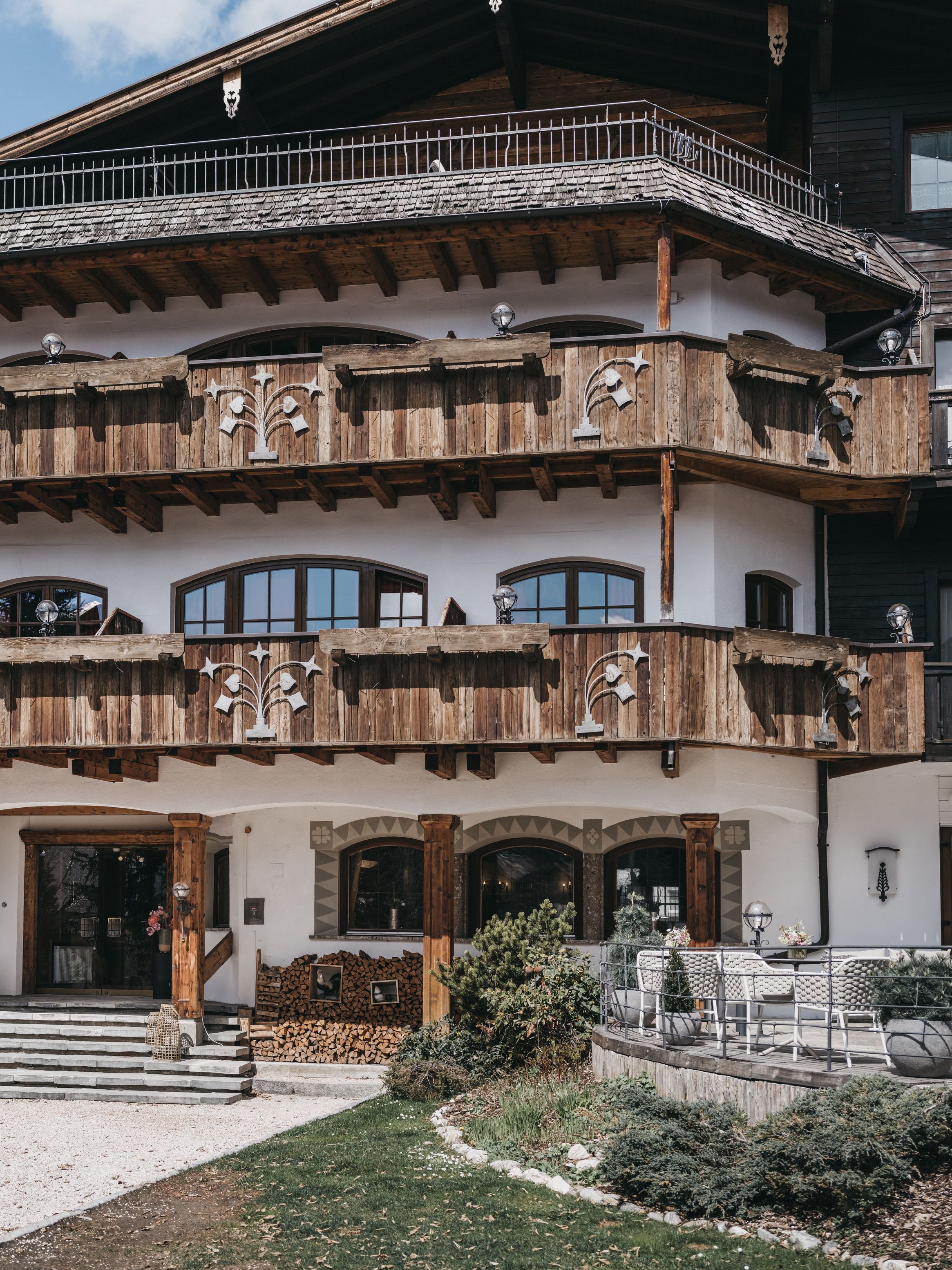 A multi-story building with wooden balconies, a stone facade, and a traditional architectural style.