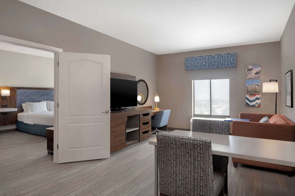 Escritorio, cortinas blackout y tabla de planchar con plancha 