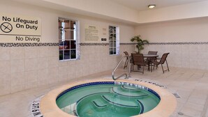 An indoor swimming pool with a 'No Diving' sign, a lifeguard duty sign, and a Whirlpool Rules sign. - Hampton Inn Van Horn (Van Horn)