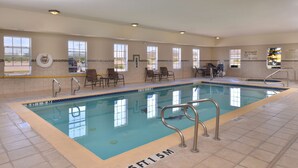 An indoor swimming pool with a 5 ft 1.5 m depth marking, surrounded by chairs and a lifeguard station. - Hampton Inn Van Horn (Van Horn)