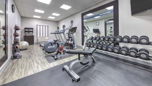 A gym with cardio machines, weightlifting equipment, and dumbbells. - Hampton Inn & Suites Lake Jackson-Clute (Clute)