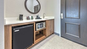 A compact bathroom with a built-in refrigerator, microwave, and sink. - Hampton Inn & Suites Lake Jackson-Clute (Clute)