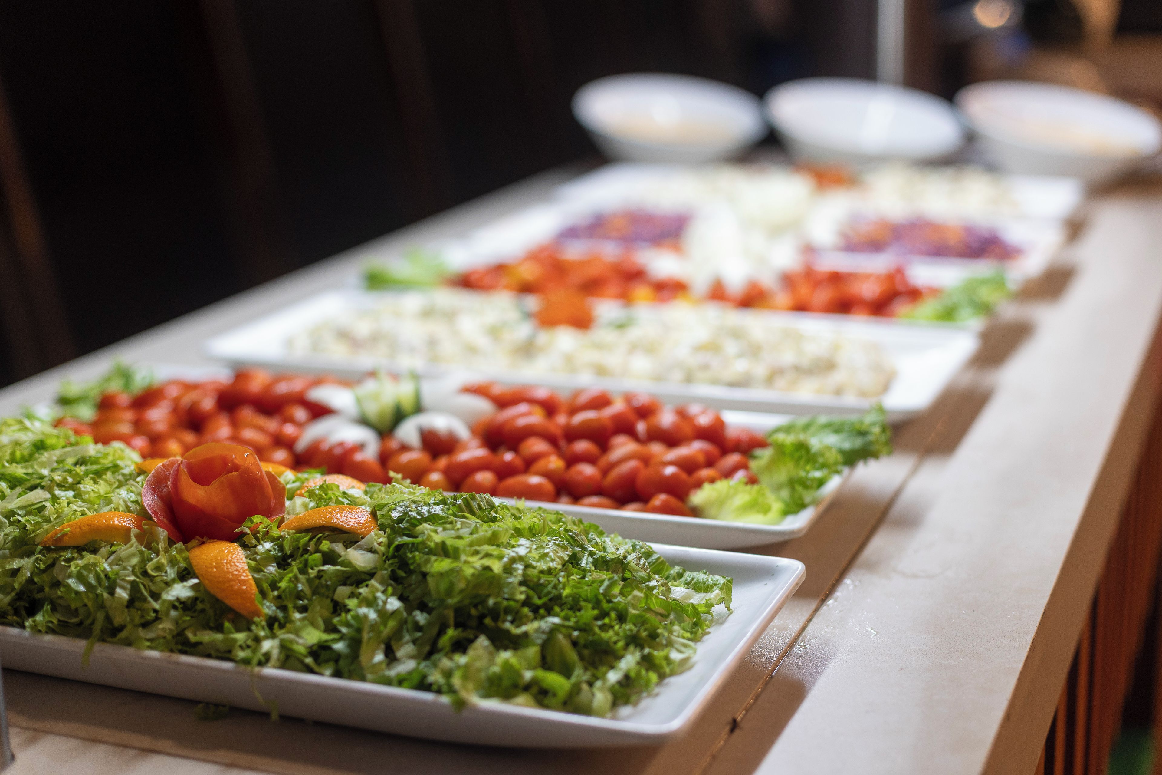 A buffet table with various food options.