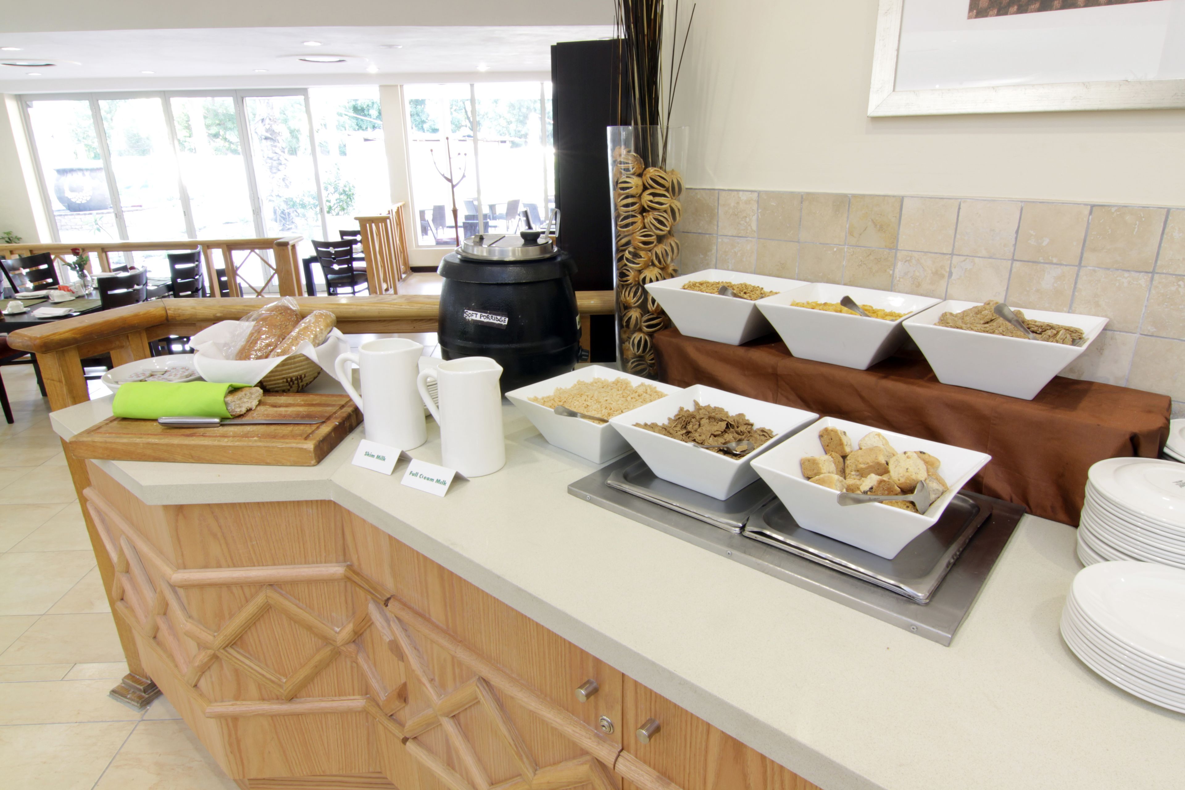 A buffet setup with various food items and a coffee station.