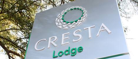 A sign for Cresta Lodge with a circular logo and the name 'CRESTA Lodge' in capital letters.