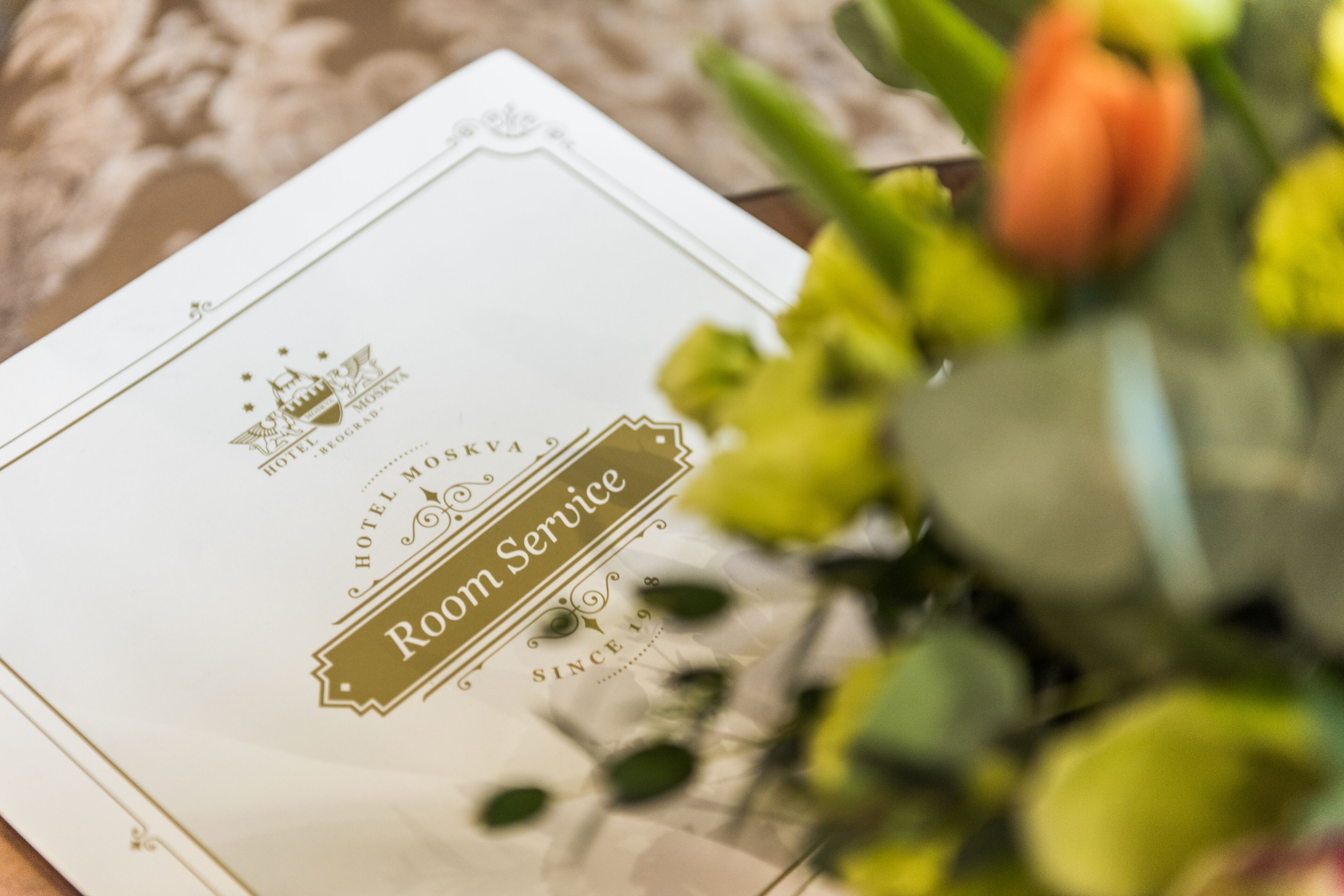 A hotel room service menu with a logo and text.
