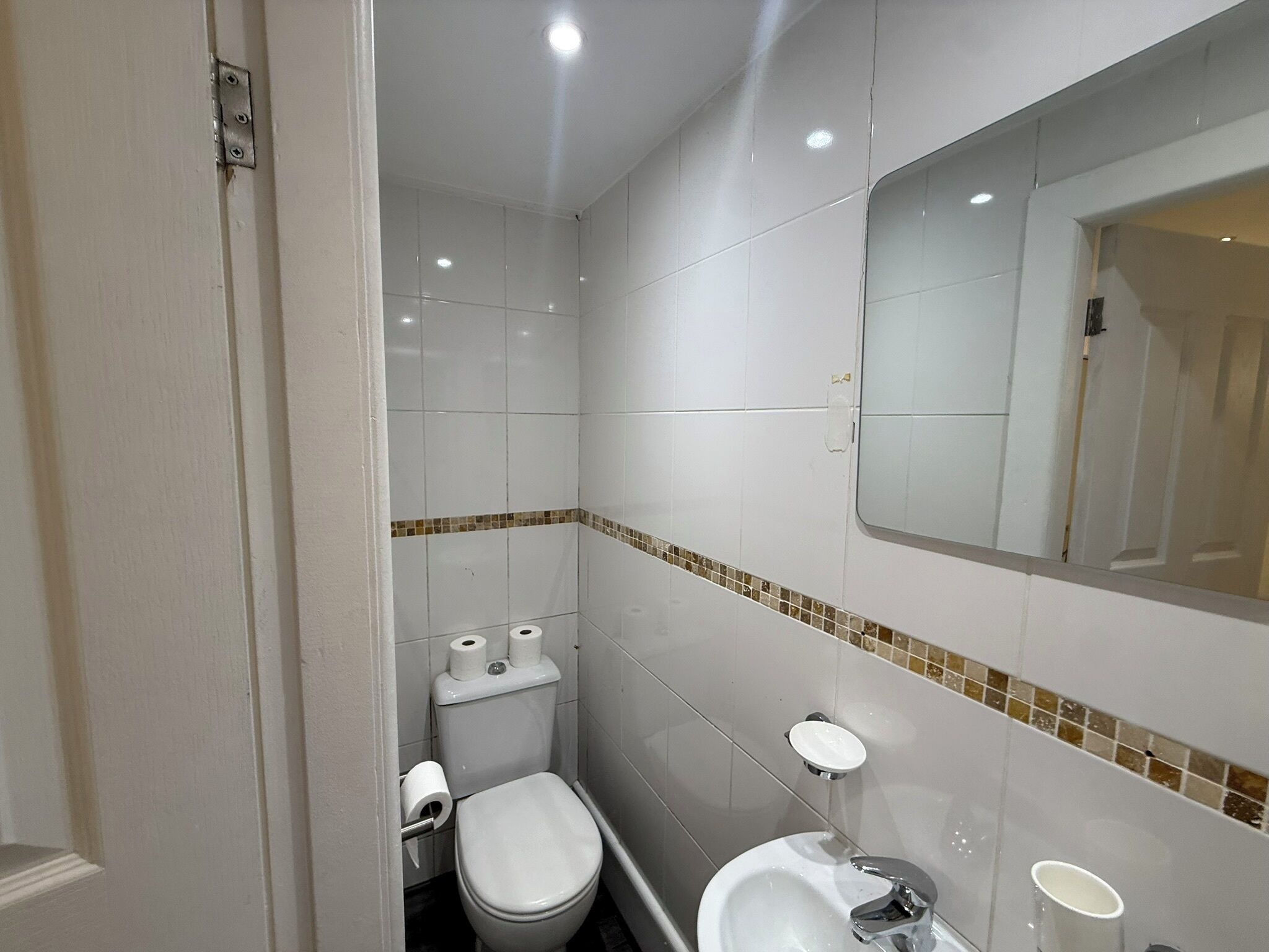 A small bathroom with a toilet, bidet, and sink.