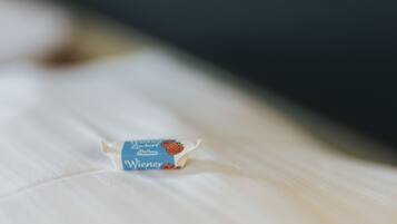 A small, blue and white package with text on it, placed on a white surface.