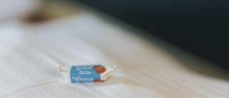 A small, blue and white package with text on it, placed on a white surface.