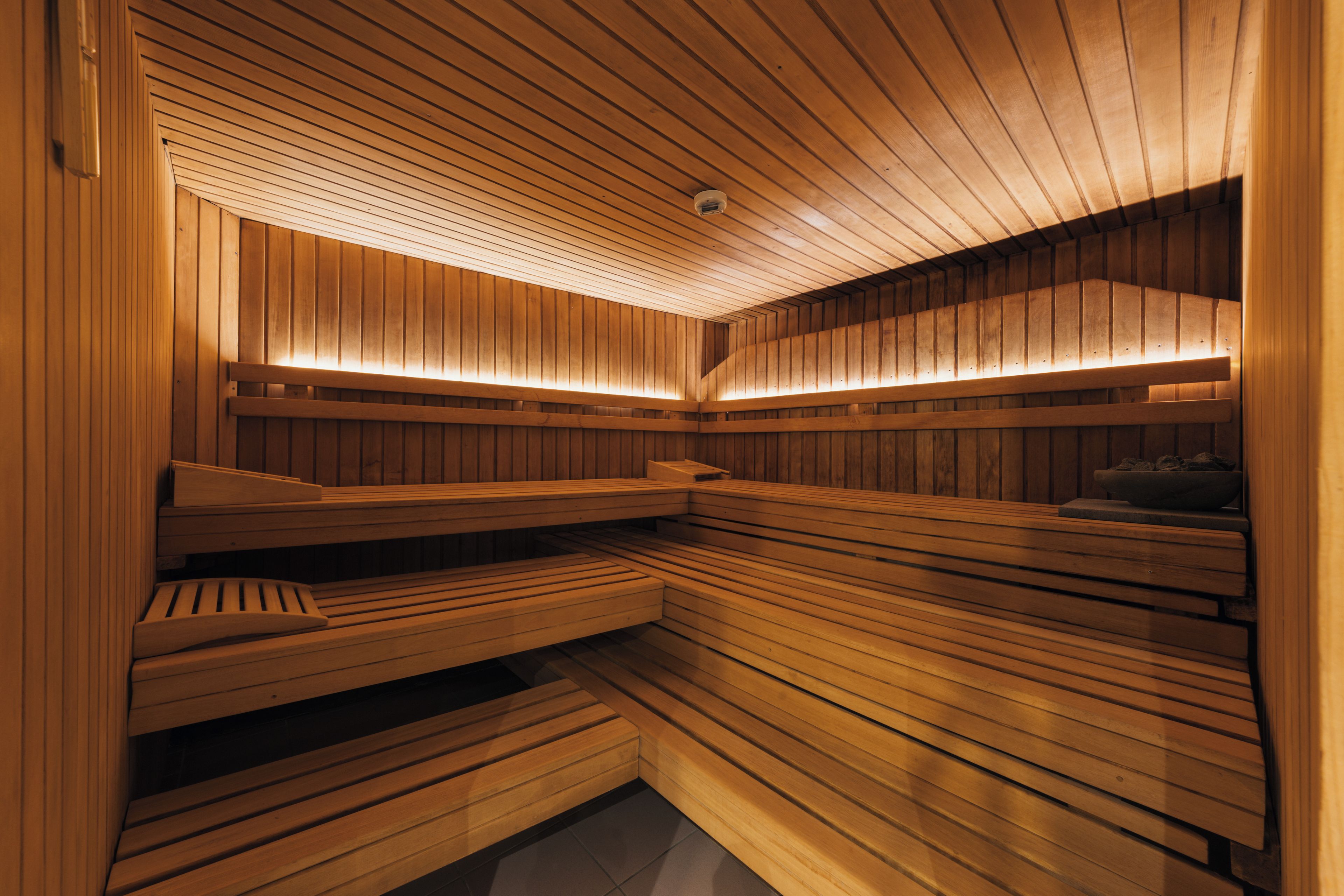 A sauna with wooden benches and slatted walls.