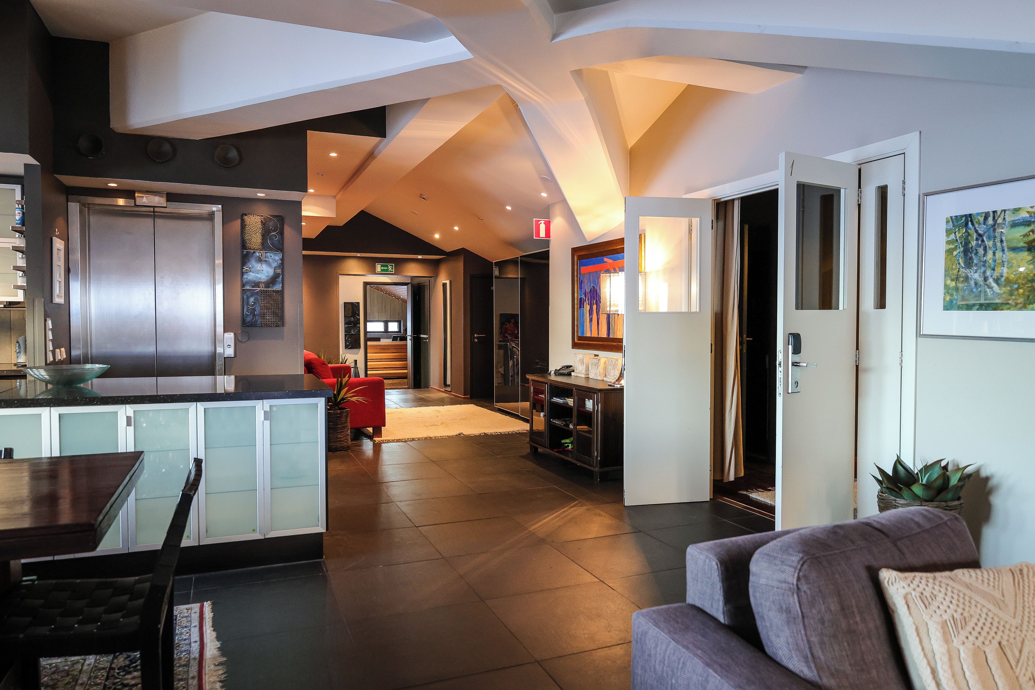 A spacious living area with a kitchen, a dining table, and a seating area.