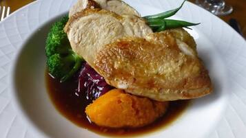 A plate with roasted chicken, broccoli, and purple cabbage.