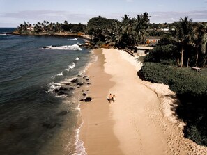 White sand, beach umbrellas, beach towels, surfing