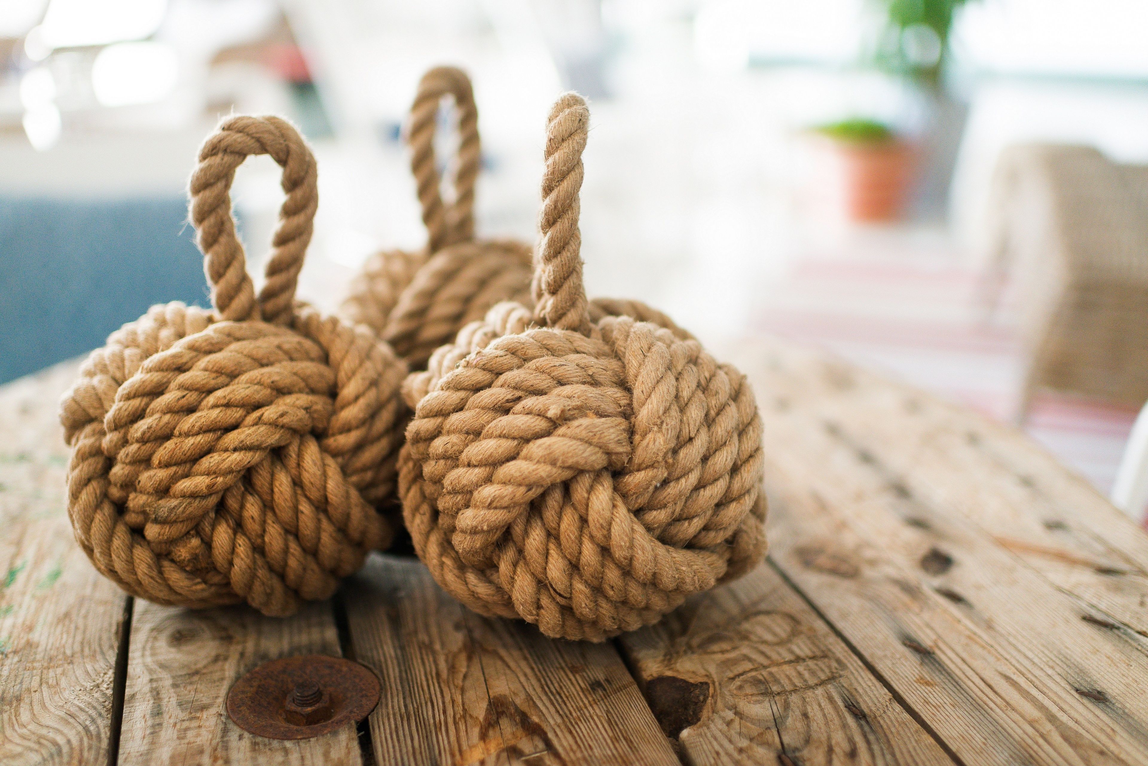 Three rope-basket handles on a wooden surface.