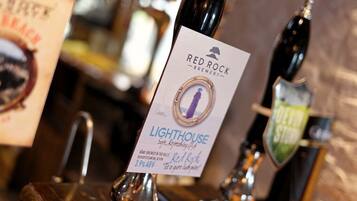 A tap labeled "Red Rock Brewery Lighthouse" with a description of the beer type and ABV.