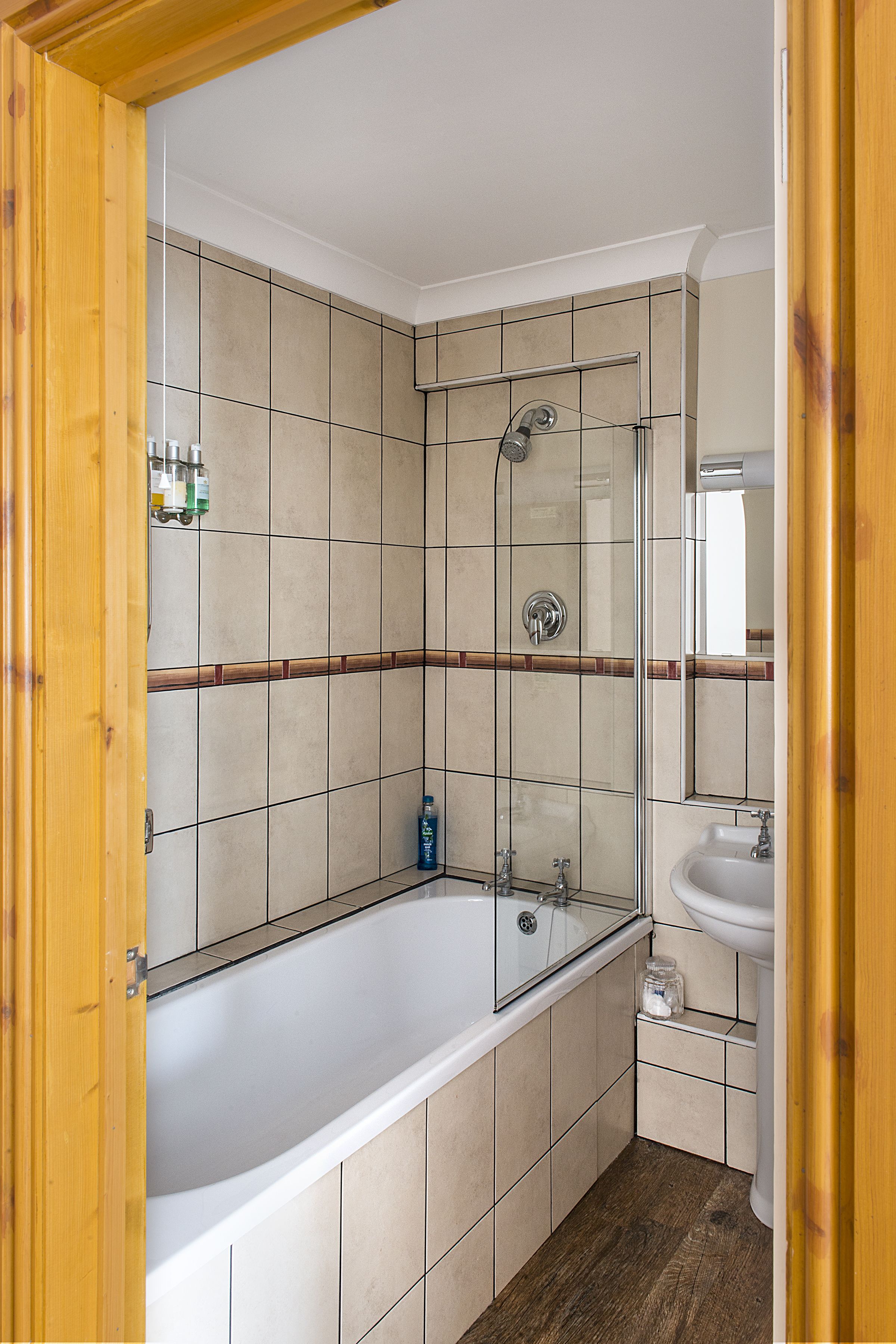 A bathroom with a bathtub, a shower, and a sink.