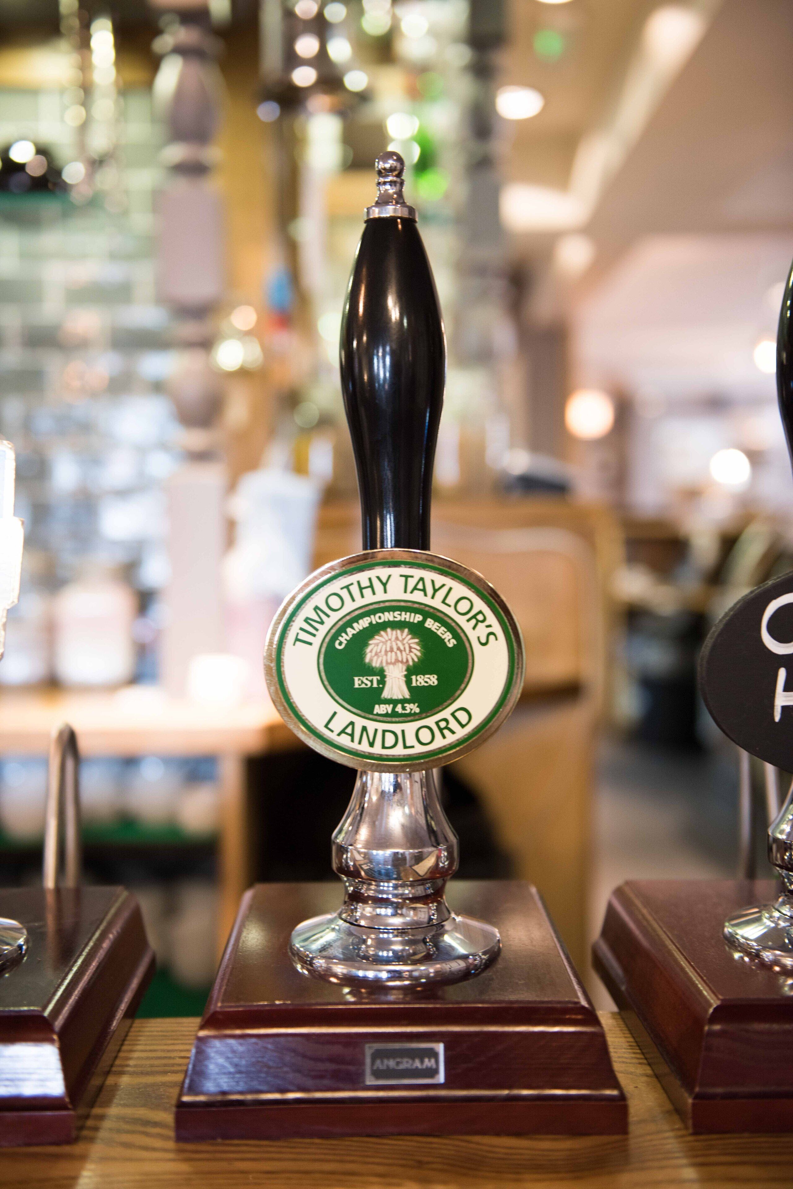 A tap labeled "Timothy Taylor's Landlord" with a wooden base.
