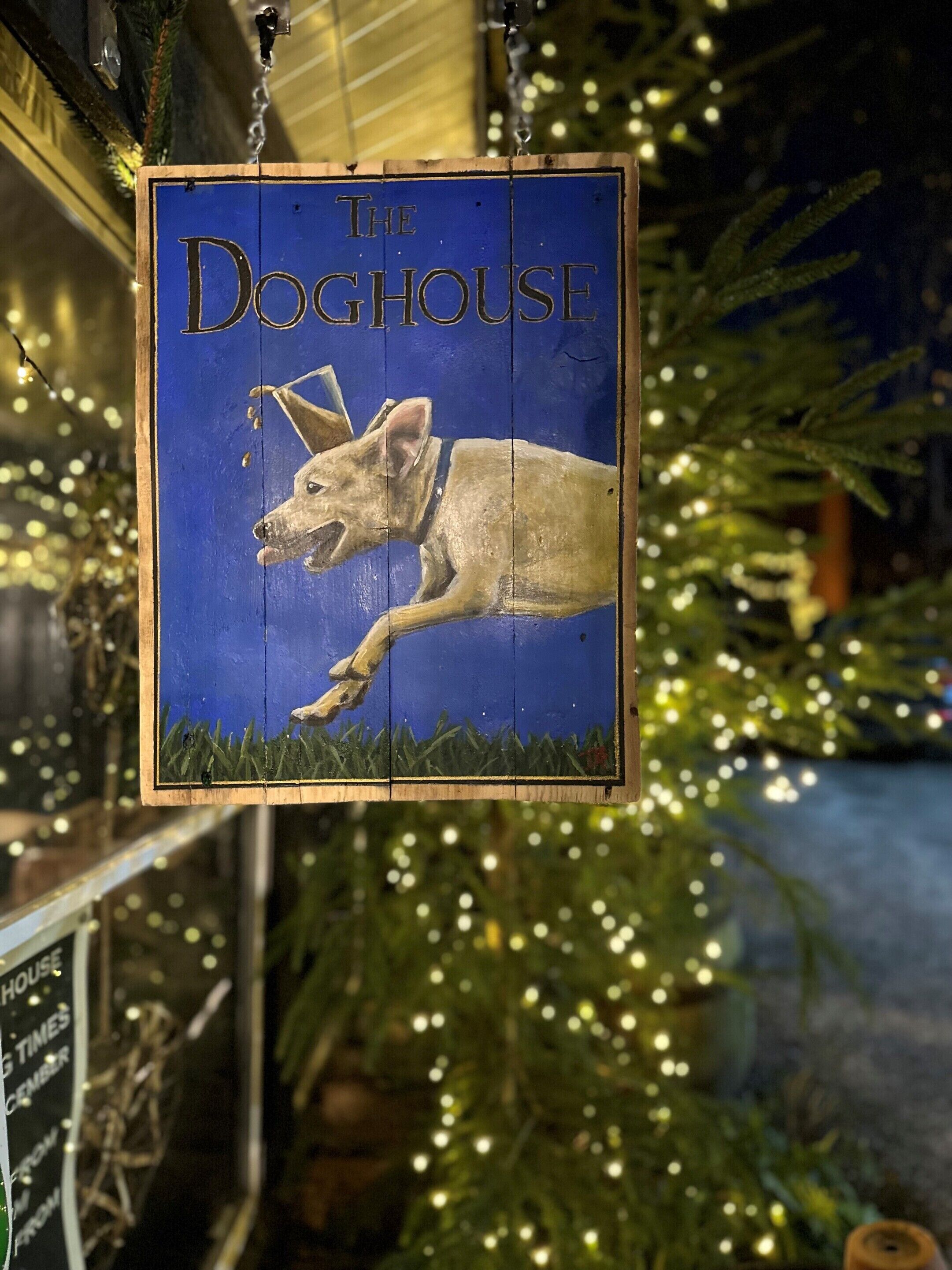 A sign for 'The Doghouse' with a dog illustration.