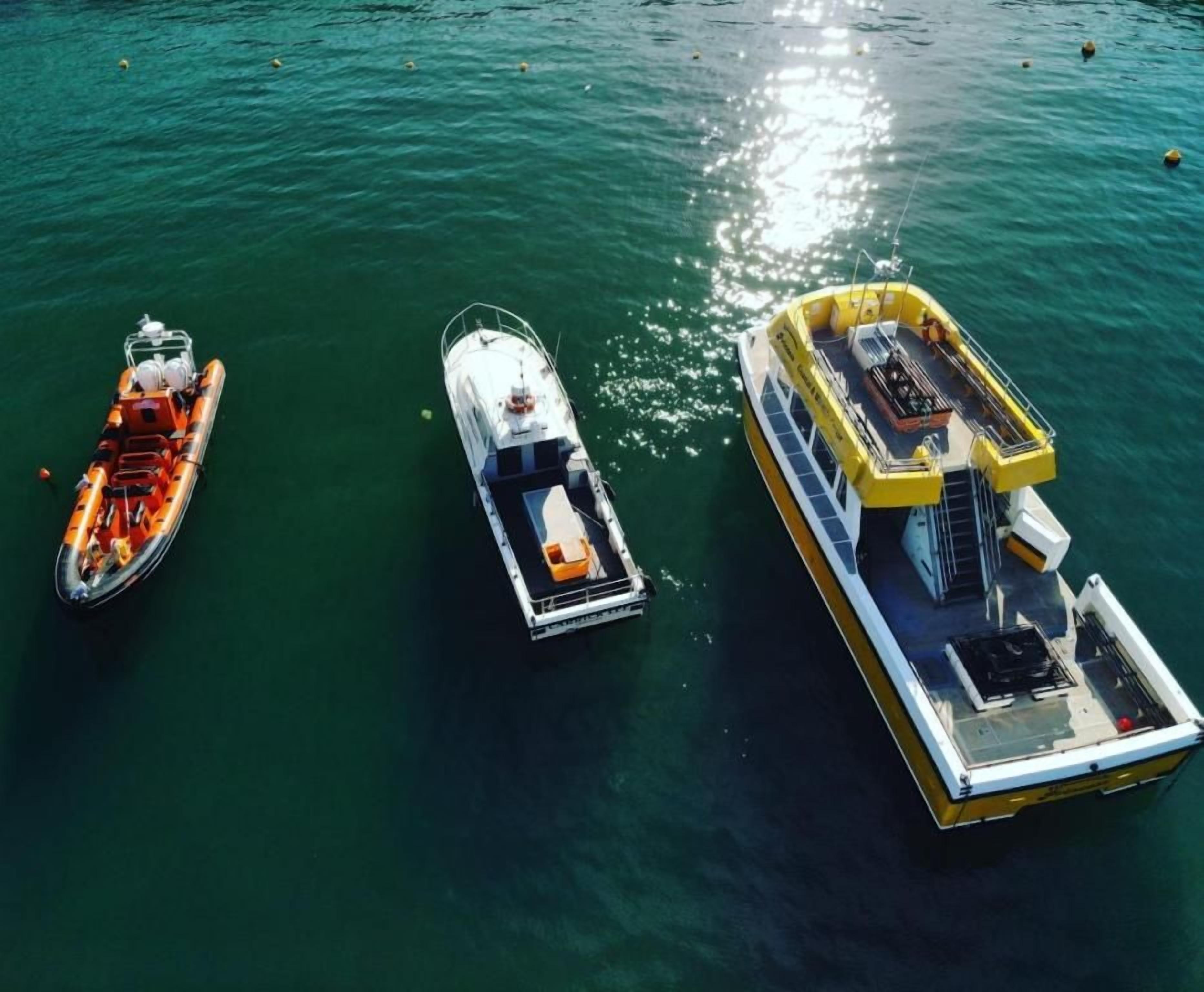 Three boats on a body of water.